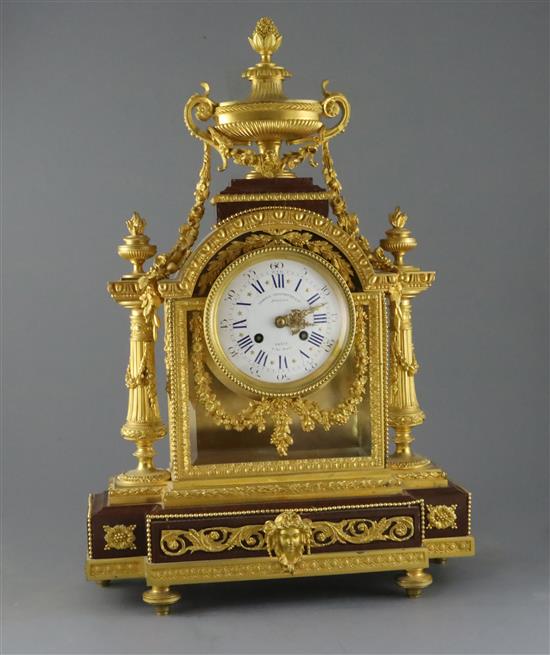 A 19th century French Louis XVI style ormolu and red marble mantel clock, H.23in.